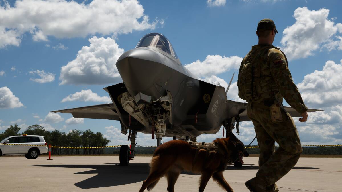 Military personnel guard the the F-35 Joint Strike Fighter jet. Picture: Max Mason-Hubers 
