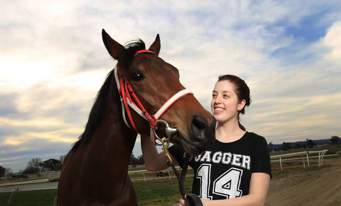 ALL SMILES: Stablehand Emma Johnstone with Ms Coru, who trainer Brian Cox is hoping can hand him a sixth Jack Maher Classic at Wodonga on Sunday. 