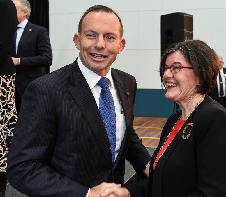 CHANGE OF TONE: Tony Abbott greets member for Indi Cathy McGowan. She said it was obvious the Prime Minister had chosen to use his visit to Wodonga to launch the Liberal campaign for Indi. Picture: MARK JESSER