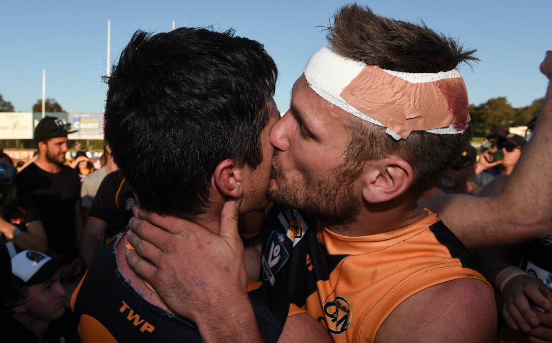 SEALED WITH A KISS: Joel Mackie and Dean Polo were among the Tigers' best as they charged to back-to-back premierships. Picture: MARK JESSER