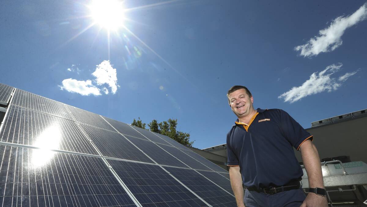 YACK CAN: Nick Cook with solar panels installed at Yackandandah FoodWorks. A reader says Australian politicians are backing a dead horse when it comes to coal.