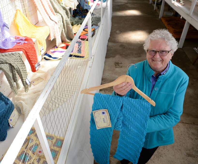 CRAFTY LADY: Heather Collis of Walbundrie got a top placing with her knitted scarf at the Walbundrie Show on Monday. Thousands turned out despite the forecast for rain. Pictures: MARK JESSER