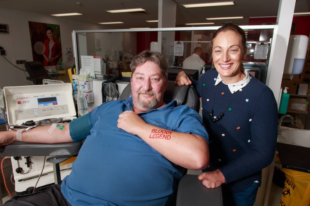 LEGEND: Dave Moore of Wodonga at his 30th blood donation in Albury on World Blood Donor Day, congratulated by Eliza Ault-Connell, who survived meningococcal disease as a teenager. Picture: SIMON BAYLISS