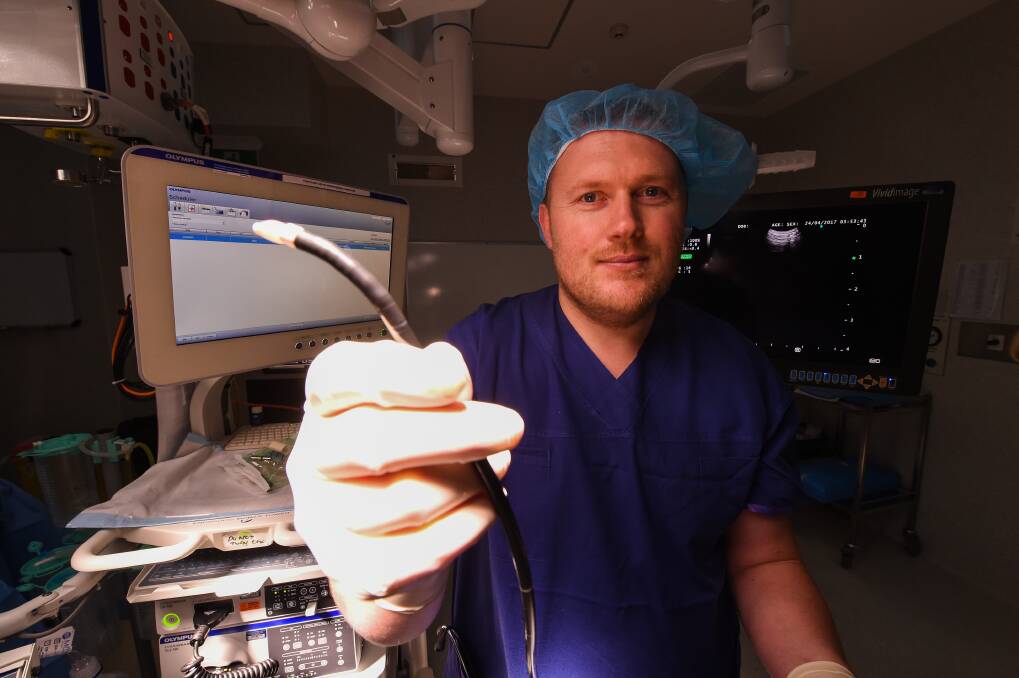ADVANCED: Dr Robertson holds up a bronchoscope, part of equipment to more quickly diagnose Border people with cancer. Picture: MARK JESSER