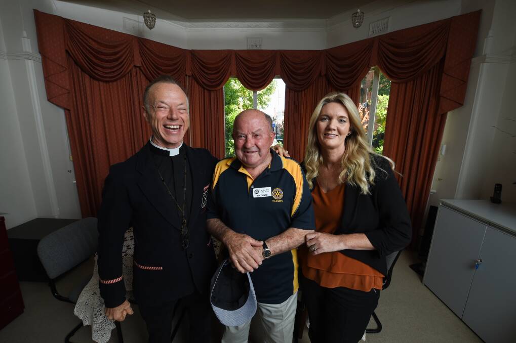 OPEN ARMS: Father Peter MacLeod-Miller, Rotary Club of Albury president Ken Curnow and Carevan's Stacey Franklin in a room to be opened to Carevan. Picture: MARK JESSER