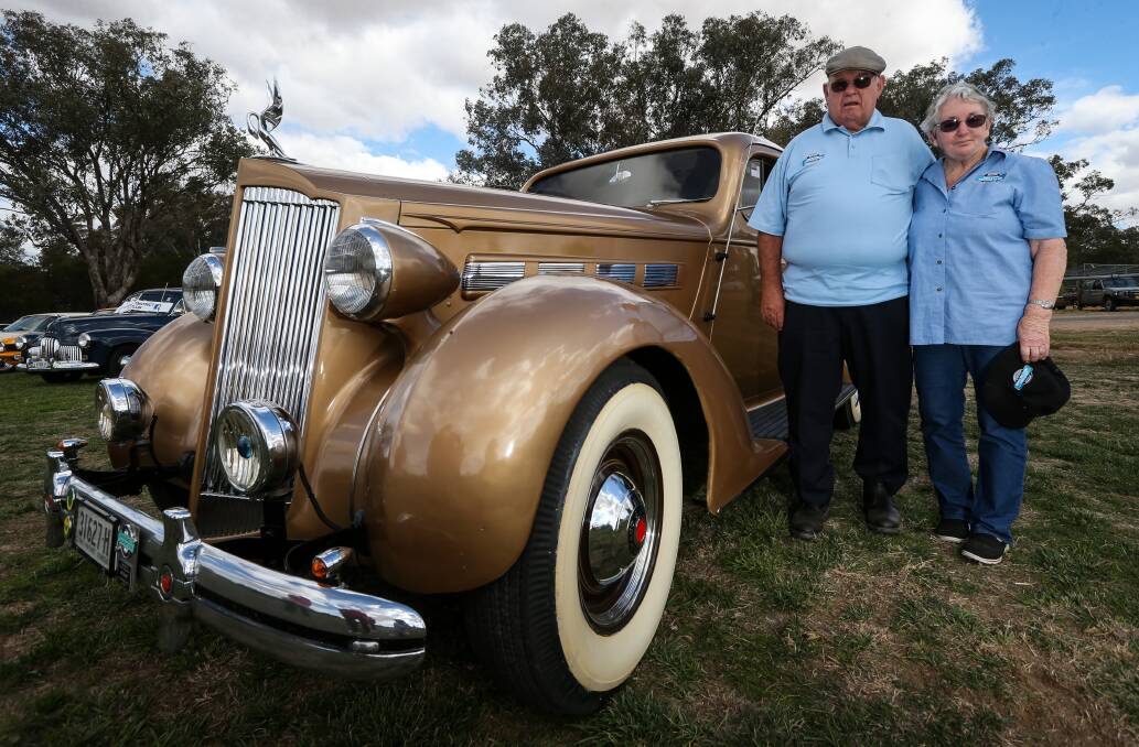 YOU BEAUTY: Harold and Sandra Upston, of Albury, with their 1937 Packard, among 150 antique car owners, at the fundraiser rally for the Burrumbuttock Hay Runners. 