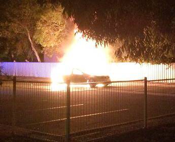 DESTROYED: A commodore was found torched in the Mirambeena Community Centre car park in Lavington about 3.45am on Monday. Albury police have made an arrest after two stolen cars were linked to multiple alleged crimes.