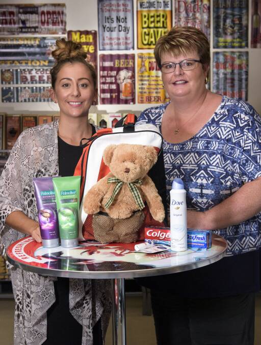 GOOD DEED: Tara Leach celebrates RAK Week with Vanessa Stelfox of Man Zone, a drop-off point for an organisation supporting foster children. Picture: SIMON BAYLISS
