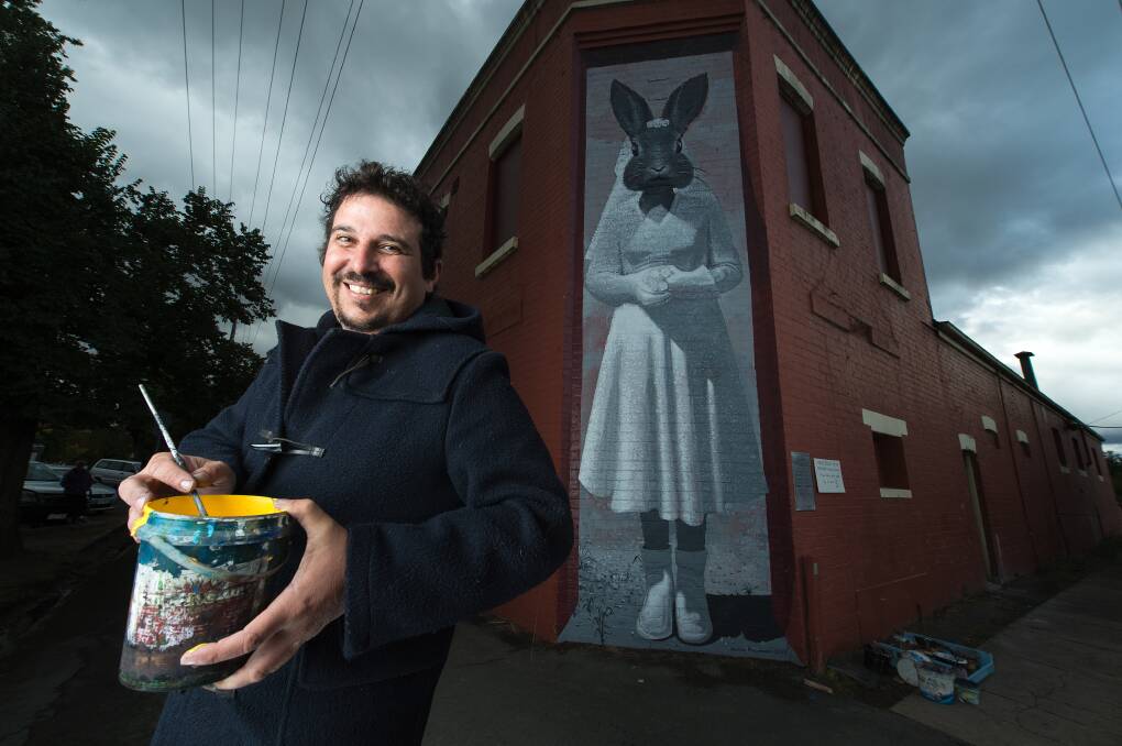 PERSONAL: It was Zest Events artist Anton Pulvirenti's first Benalla Wall to Wall Festival over the weekend, featuring 27 artists. The Sydney man created a piece honouring his family's experience in World War II. Picture: MARK JESSER