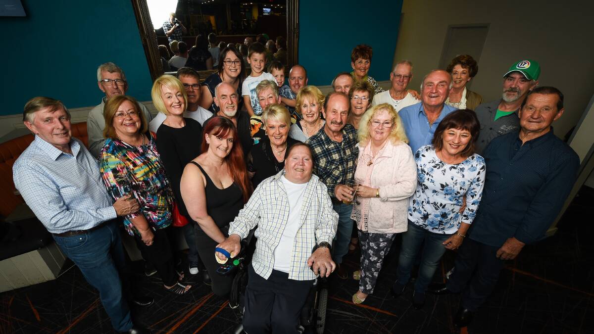 Peter Kuprijanow, who was made quadriplegic after an accident in the Kiewa River, is surrounded by family and friends at his '50 years in a wheelchair' celebration on Saturday night. Picture: MARK JESSER 