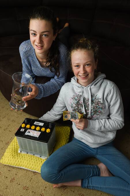 GIVING: Wodonga twins Aleisha and Lauren Coyle, 13, have been fundraising for Country Hope for years, selling craft and collecting old batteries. Picture: MARK JESSER