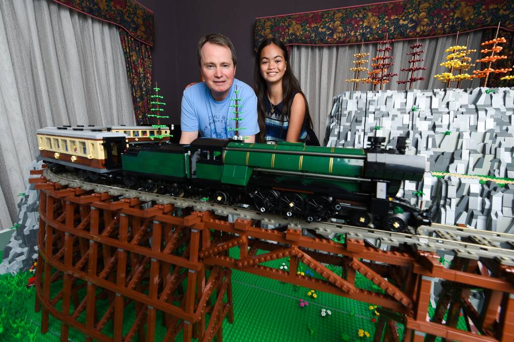 ON TRACK: Bricks on the Border member Neil Strachan with his daughter Kaitlyn, 10, check over his display that will be at the Murray Railway Modellers show this weekend at the Mirambeena Community Centre. Picture: MARK JESSER