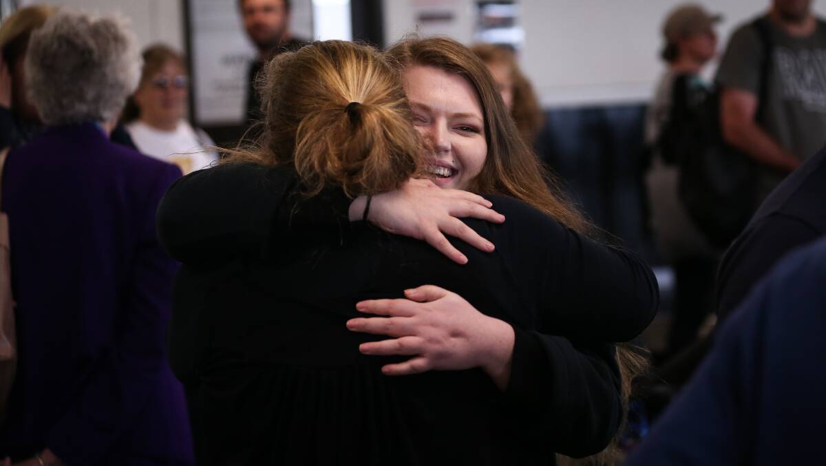 Emily Hewatt embraces friend Ria Crisp, returning from receiving treatment in New Jersey.