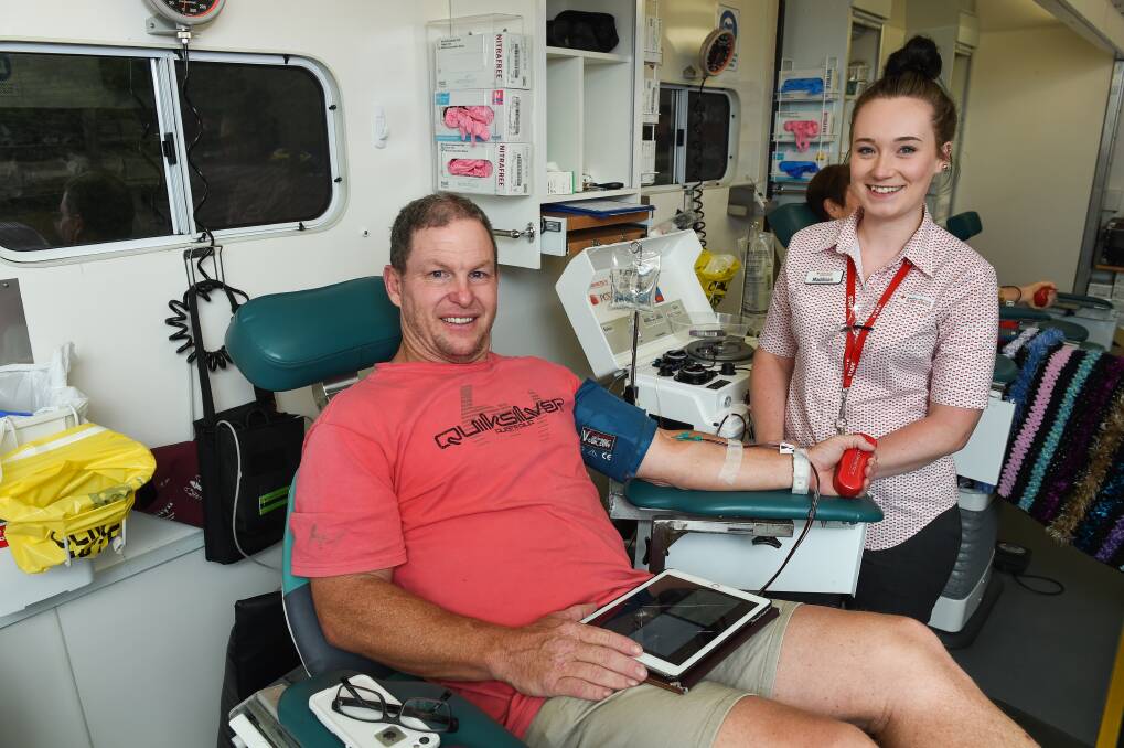MOBILE: John Stead from Jindera donates blood in the temporary van as Nursing Assistant Maddison Stein assists. Picture: MARK JESSER