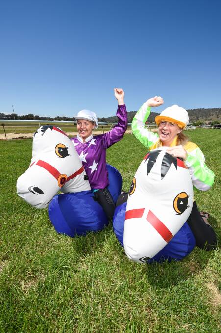 GEARING UP: Commercial Club's Gabby Wilson and Narelle Hamilton of Elders Real Estate (Residential) Albury Wodonga test out the new ponies. Picture: MARK JESSER