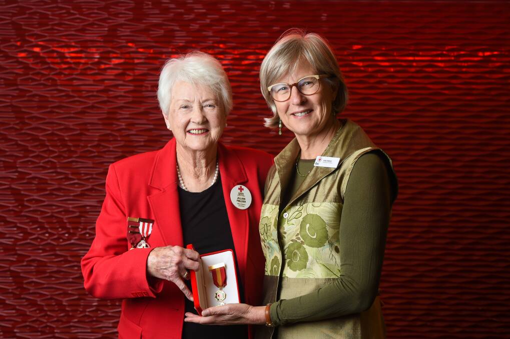 HONOUR: Albury woman Jillian Fielder receives life membership at the Red Cross, congratulated by chief executive Judy Slatyer. Picture: MARK JESSER