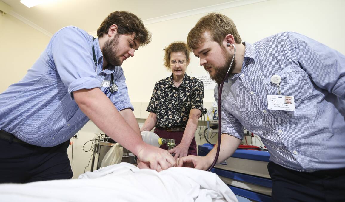 HANDS-ON: Albury Wodonga Health interns Archie Collyer and Dave Phelps simulate basic life support with the help of doctor Heather Chaffey. Picture: JAMES WILTSHIRE