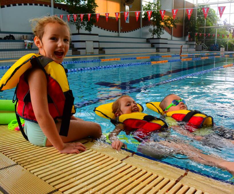 IN THE KNOW: Sophie Poulton, 3, Jasmine Poulton, 5, and Theo Podmore, 4, learn how to rescue friends during open water swimming safety classes at Wodonga Sports and Leisure Centre. Picture: ELLEN EBSARY