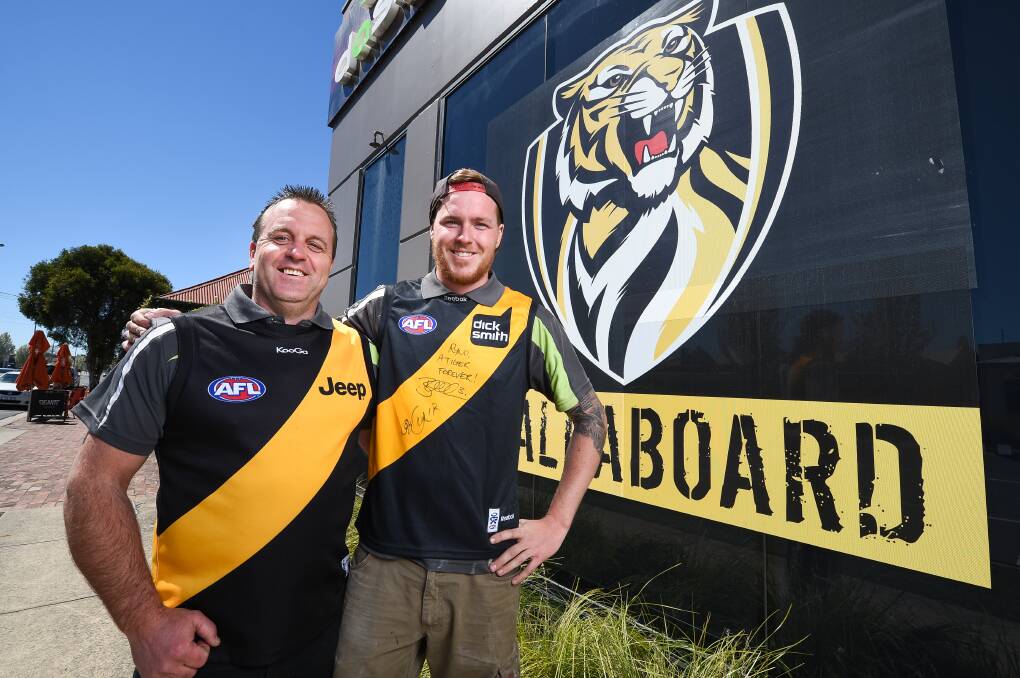 ROARING WITH PRIDE: D A Signs in Wodonga is caught in footy fever with owner Darren Andrews and his son Josh hoping for a Richmond win. Picture: MARK JESSER