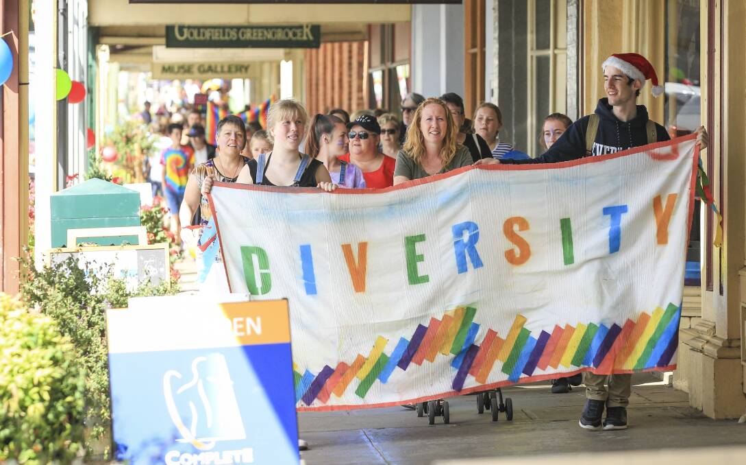 SOLIDARITY: Beechworth mum Tania Sutton (middle) leads about 700 people through town on the first diversity walk. Picture: JAMES WILTSHIRE
