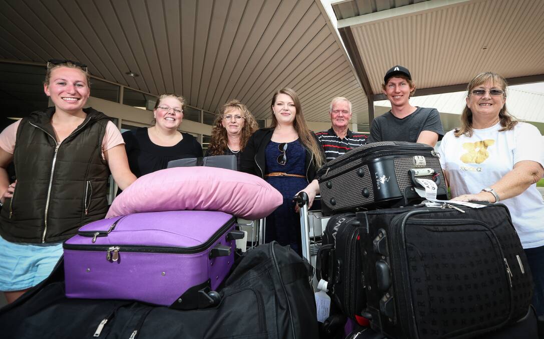 HOME: Emily's friends and family: Katie Hewatt, Ria Crisp, mum Alison, Alan Moore, Josh Healy and Vivienne Moore welcome her back at Albury airport.