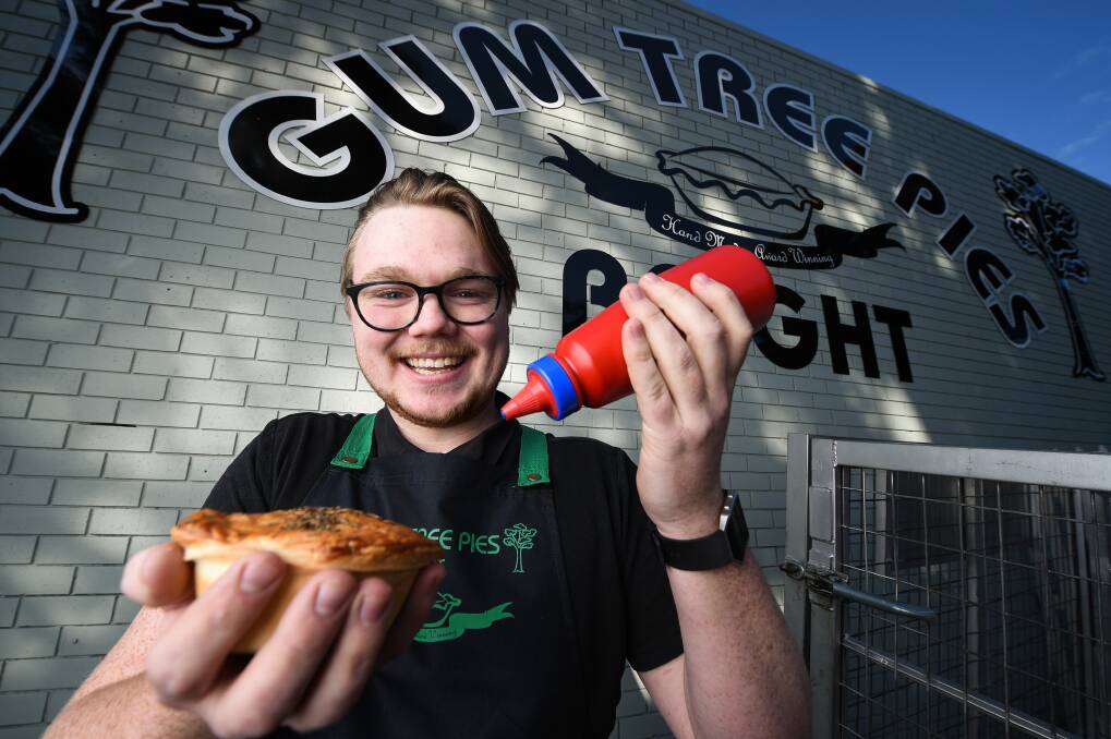 HOT OUT OF THE OVEN: Gum Tree Pies Bright manager Codey Keeble celebrates the shop's opening after it was damaged. Picture: MARK JESSER