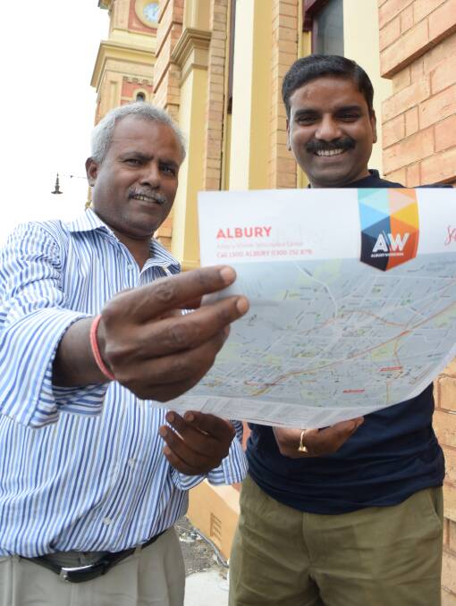 PLANNING BEGINS: Arun Kumar, from Melbourne, helps Rajesh Kumar plan a holiday in Albury after stopping en-route to Canberra as part of his first-ever trip to Australia.