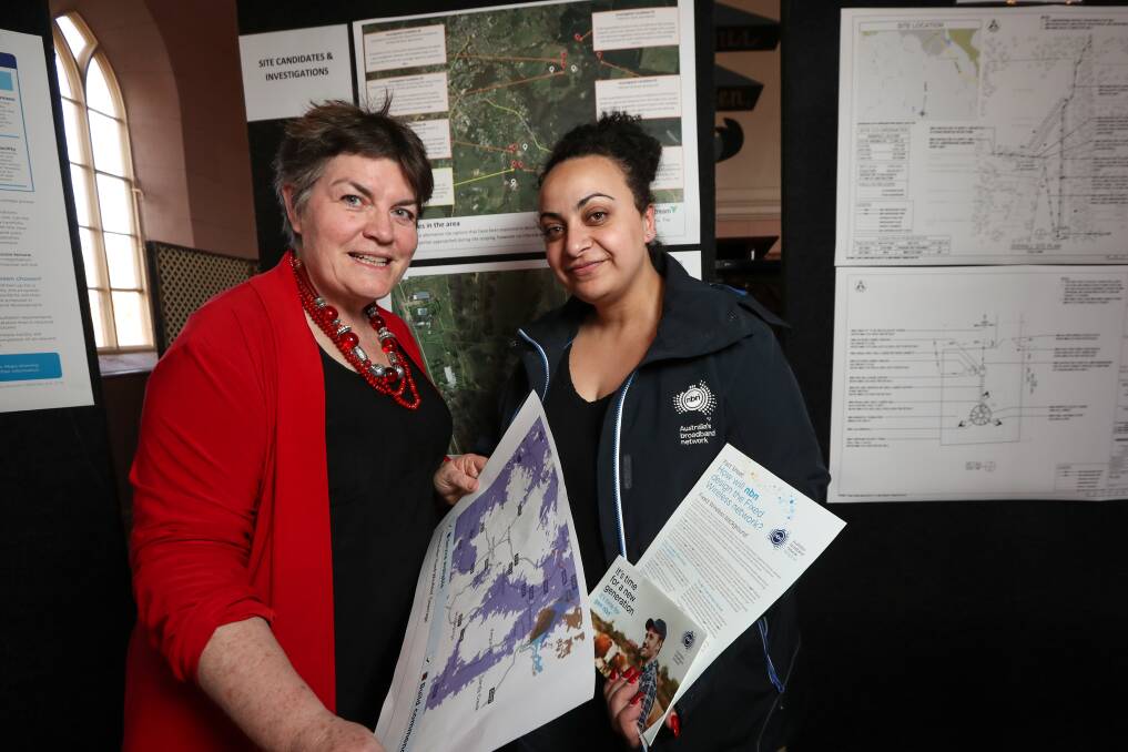 UPDATE: Helen McGowan peruses plans for the NBN fixed wireless facility in Beechworth with NBN local manager Amy Jaballah. The tower, if approved by council, will service about 200 premises. Picture: JAMES WILTSHIRE