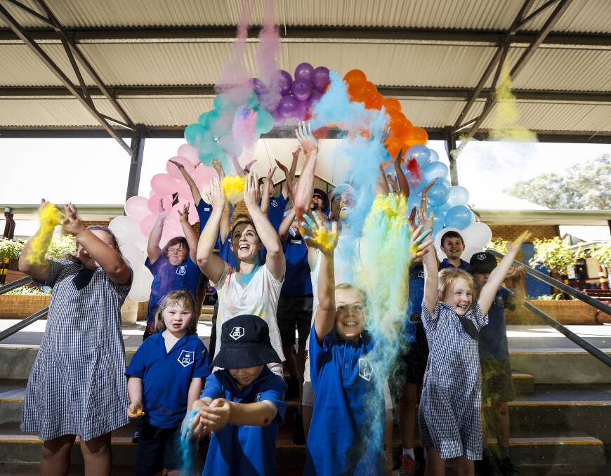 COLOUR ME HAPPY: Thurgoona Public School teachers Carly Margosis and Luke Adams copped a taste of the colours ahead of the run on March 25. Picture: JAMES WILTSHIRE