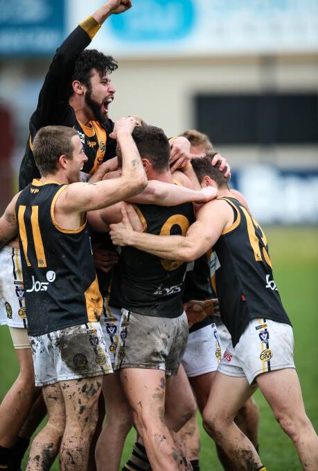 ALL IN: Josh Mellington was mobbed by his Tigers' teammates after kicking his 100th goal for the season. He cracked the ton last season with Benalla as well.