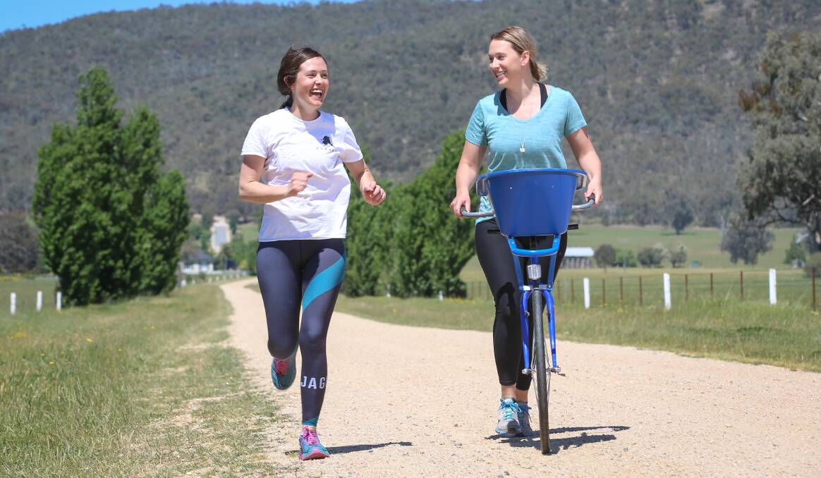 KEEP GOING: Sarah Fisher and Ash Argoon make the gruelling ascent from Beechworth to Mt Buffalo this weekend. Picture: JAMES WILTSHIRE