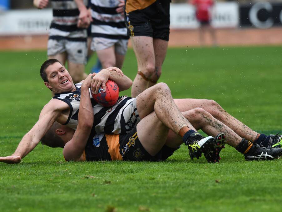 ROUGH AND TUMBLE: Dean Bigger was one of the Pigeons' best in a tough, physical contest on Sunday afternoon. Picture: MARK JESSER