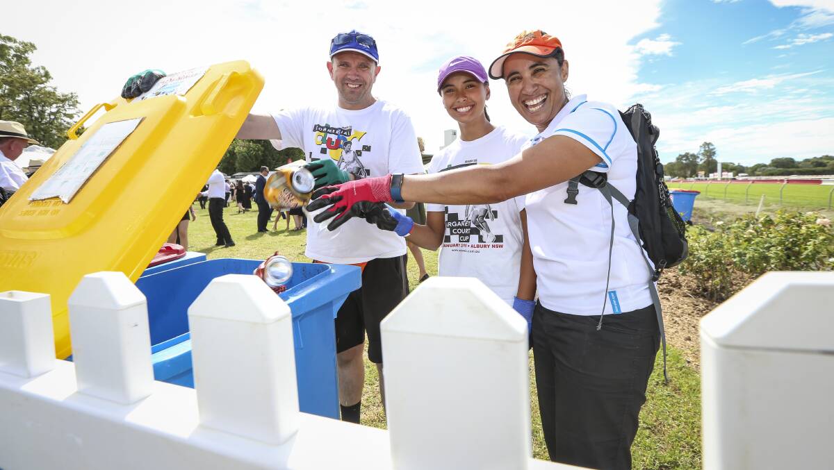 TAKING OUT THE TRASH: Simon, Cameron, 13, and Mercedes Goss and the rest of the Margaret Court Tennis Academy were out in force on Friday, keeping the trackside looking its best for Gold Cup day. Picture: JAMES WILTSHIRE