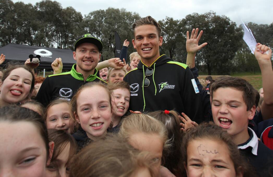 ALL SMILES: There was no escaping the excitable kids at Trinity Anglican College for Sydney Thunder stars Ryan Gibson and Chris Green. 