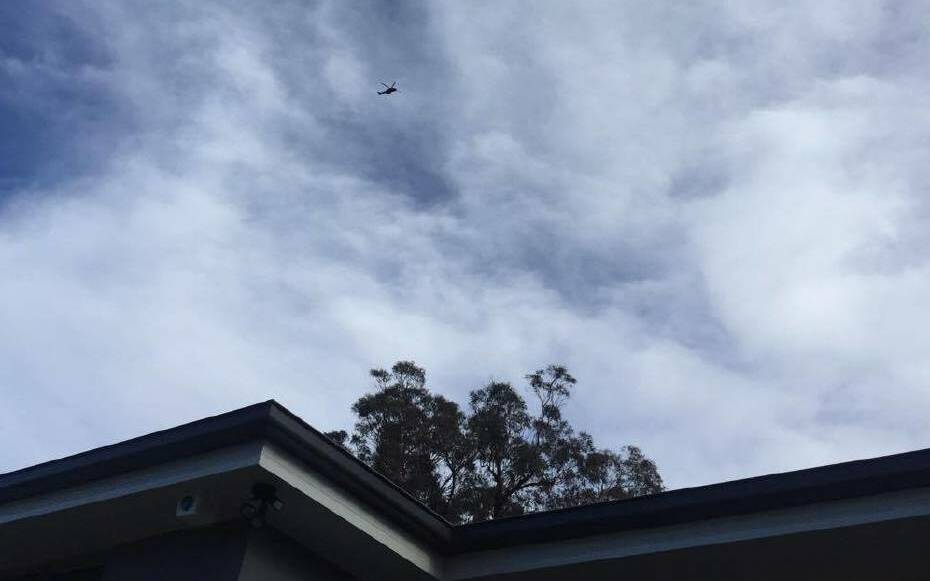 A Polair chopper searches Warilla from the sky, Thursday afternoon. Picture: Alexis Paule