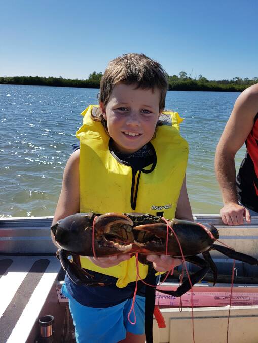 RIPPER: Mitchell Clarke, 9, caught this mud crab while on holidays on Queensland's Boyne River.