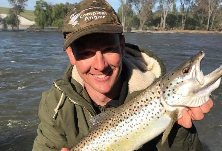 NICE CATCH: Ben Mason with a nice trout he caught near the Hume Weir wall. The weather is looking excellent for the next couple of days, which should be fantastic for fishos.