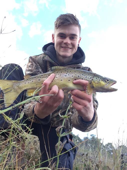 YOU BEAUTY: Connor Heir with a colourful trout he caught while casting off the bank with a bullet lure at Dartmouth.