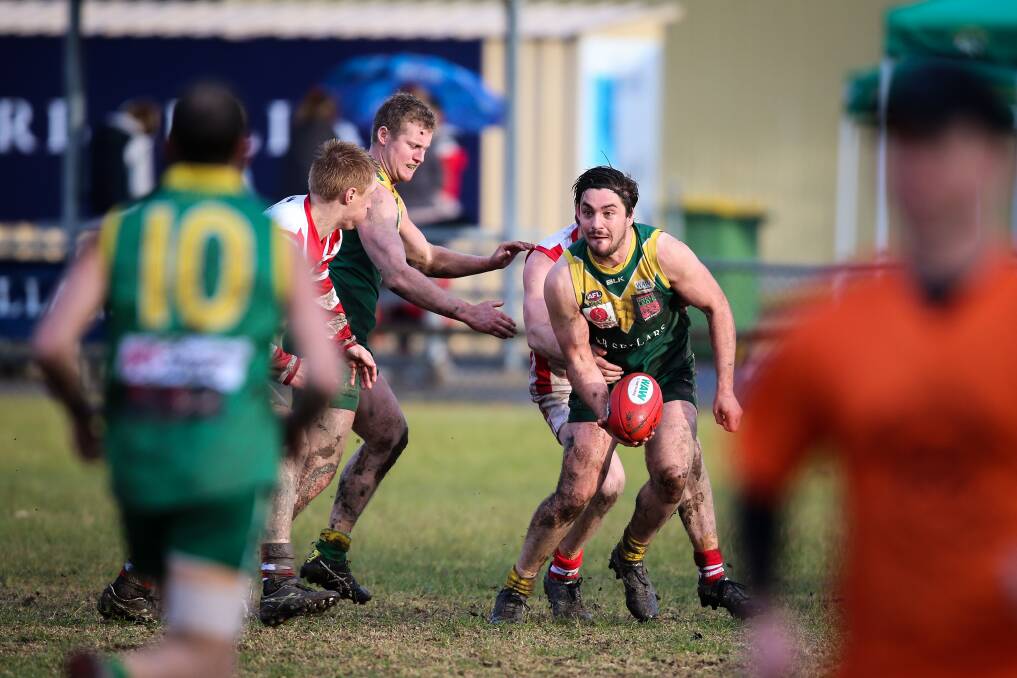 QUICK HANDS: Holbrook's Josh Jones looks for a teammate during his side's clash with Henty. Picture: JAMES WILTSHIRE