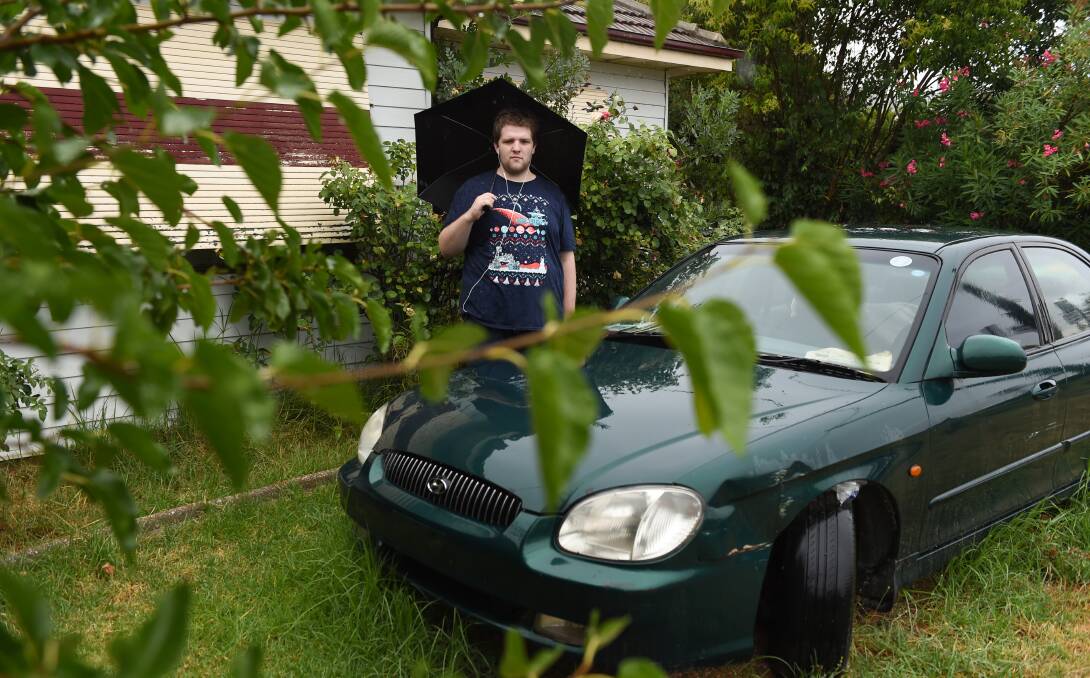 IT CAME FROM THE SKY: James Frost in the front yard of his Albury home where a man in only underwear jumped off his roof. Picture: MARK JESSER