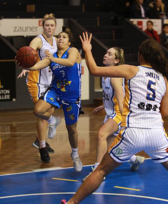 BRITTEN BLAST: Lady Bandits' guard Shelby Britten whizzes by the Canberra Captials Academy defence. Pictures: PETER DE KRUIJFF