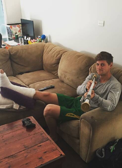 COUCH-BOUND: Wooragee bike rider Dean Lucas at home with his injury.