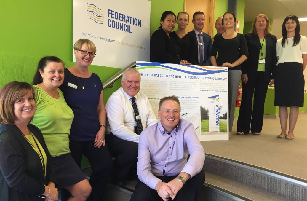 NEW BEGINNINGS: Federation Council staff members with updated logo and signage ticked off by administrator Mike Eden on Tuesday.