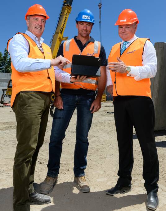 ON TRACK: Mann Central developer David Maxwell, project manager Andrew Cameron and leasing agent Steve Martin at the construction site. Picture: MARK JESSER