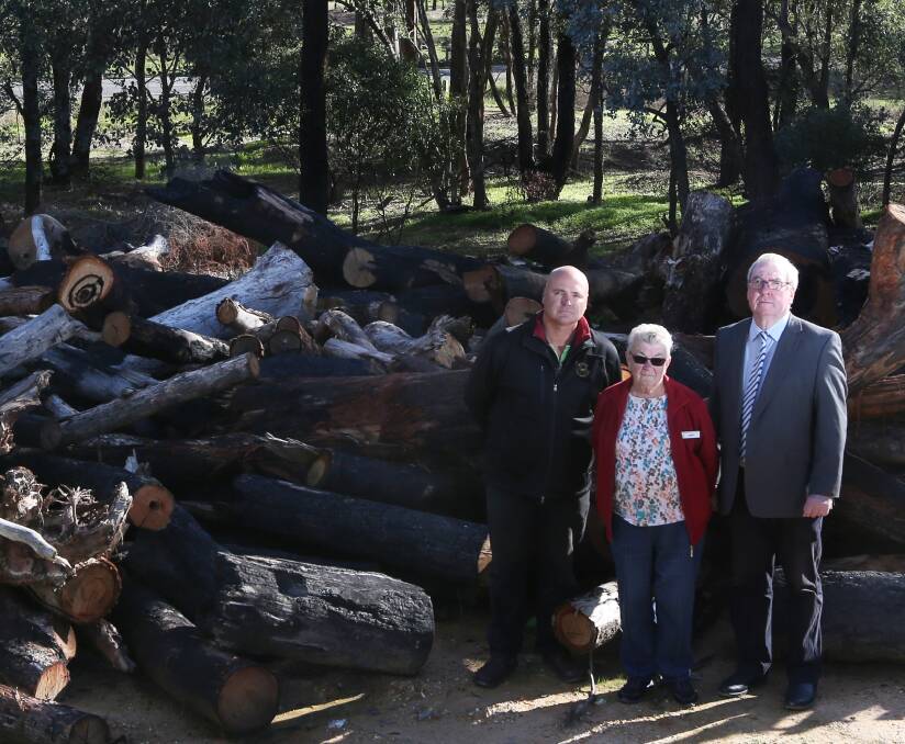FIRED UP: Indigo Shire councillors Emmerick Teissl, left, and Bernard Gaffney with Chiltern pensioner Mary Jackson with firewood available to be used. Picture: ALEISHA McCARRON