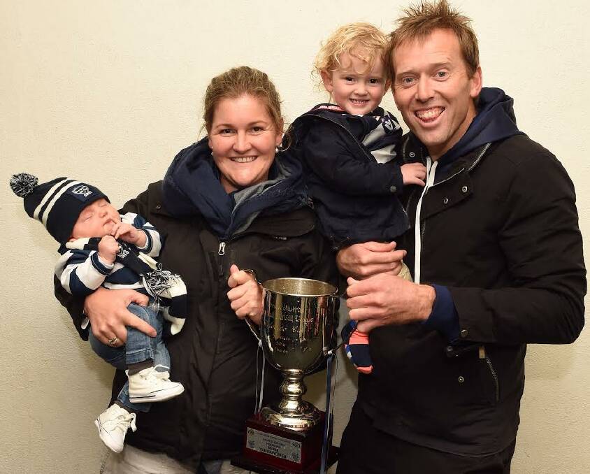 FAMILY AFFAIR: Yarrawonga under-18s premiership coach Marcus Cummins with wife Kaitlyn and children Jack, 12 weeks, and Ollie, 1, following the win against Wangaratta. Pictures: MARK JESSER