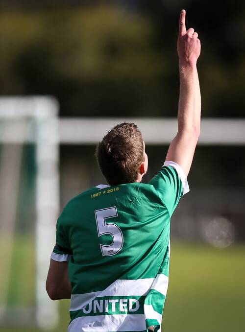 ONE FOR LES: Albury United player James Mason points to the sky in memory of Les O'Brien on Sunday. Picture: JAMES WILTSHIRE 