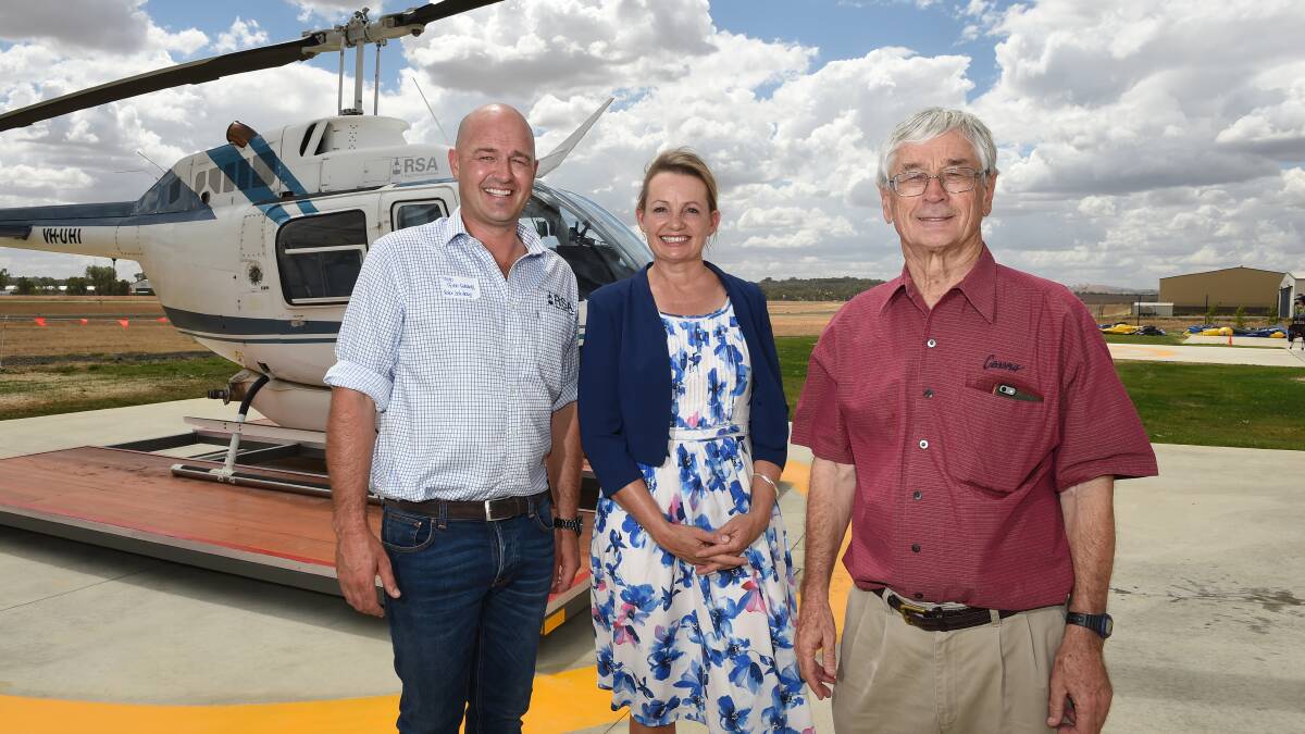 FLYING HIGH: Rotor Solutions Australia owner Hugh Acton-Adams, Farrer MP Sussan Ley and Dick Smith at the company's official opening on Saturday. Picture: MARK JESSER