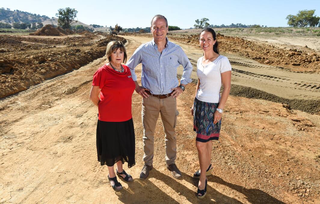 UNDER CONSTRUCTION: Wodonga Real Estate's Margy Meehan, left. and Kiewa Valley Estate developers Andrew and Jenny Stern on Gibson Boulevard. Picture: MARK JESSER