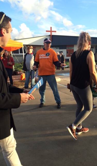 SNAPPED: A Cathy McGowan volunteer wearing a CFA cap at the Wodonga pre-poll centre on Wednesday.
